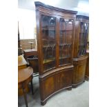 A mahogany freestanding concave corner cabinet