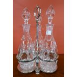 A silver plated decanter stand with three cut glass decanters