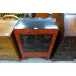 A Chinese black and red lacquered chinoiserie side cabinet