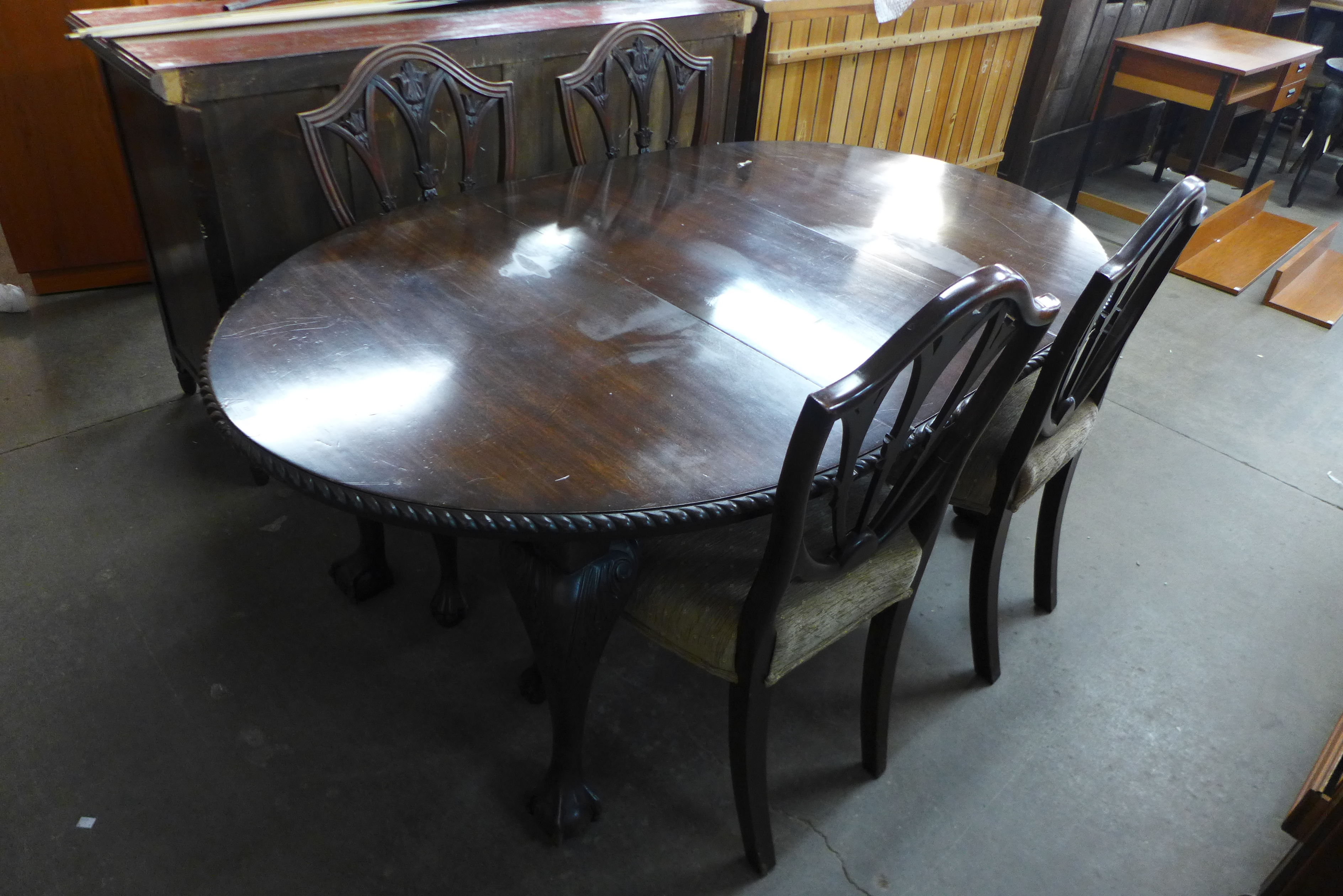 A late Victorian mahogany extending dining table and a set of four Hepplewhite style dining chairs