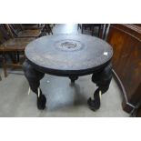 An early 20th Century eastern carved ebonised circular occasional table