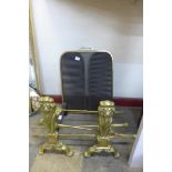A pair of brass and cast iron andirons, fire screen and a companion set