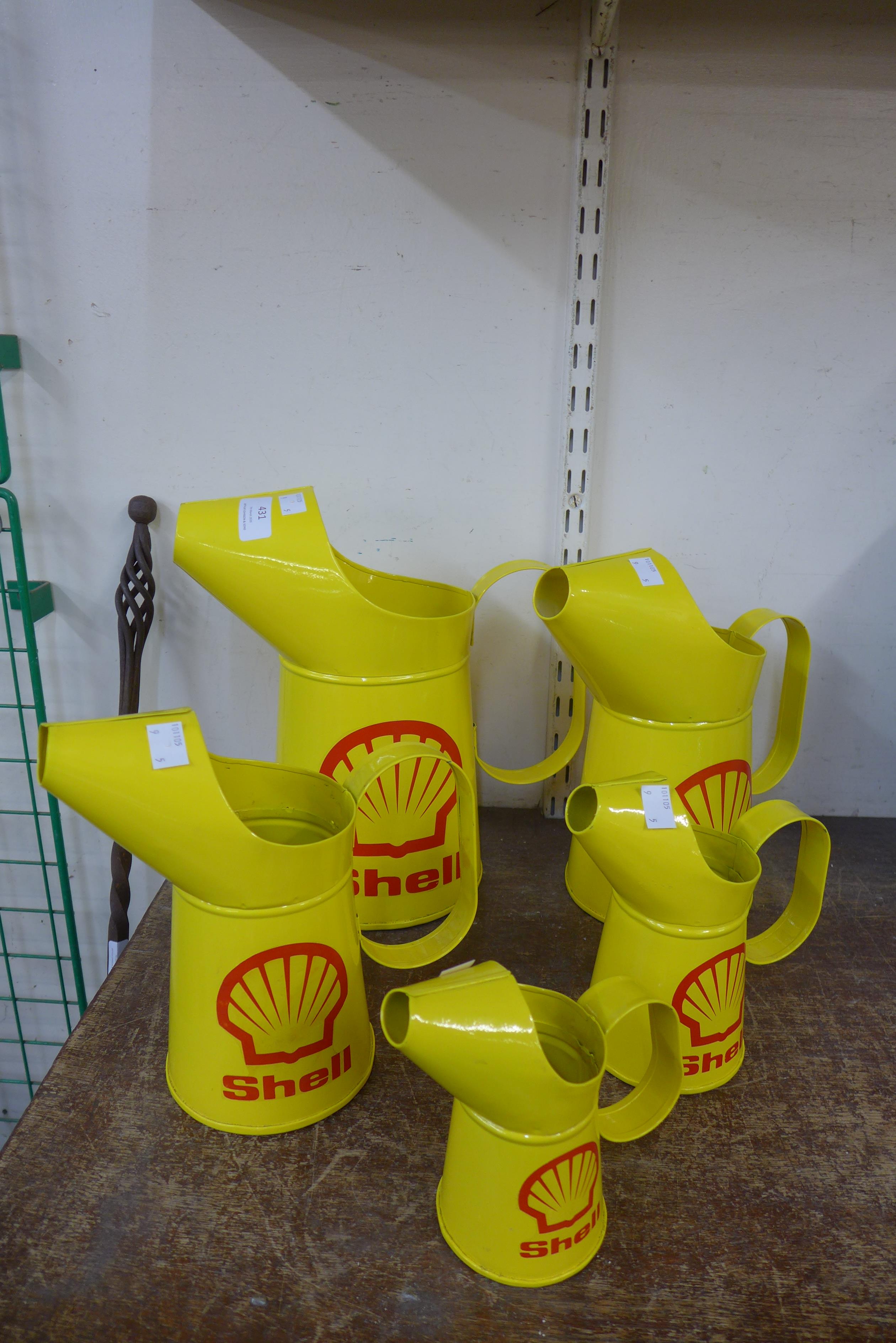 A set of five reproduction graduated Shell oil cans