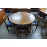 A teak extending dining table and four chairs