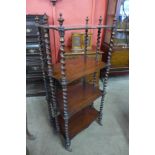 A Victorian rosewood serpentine four tier whatnot