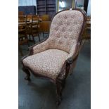 A Victorian carved walnut and upholstered armchair