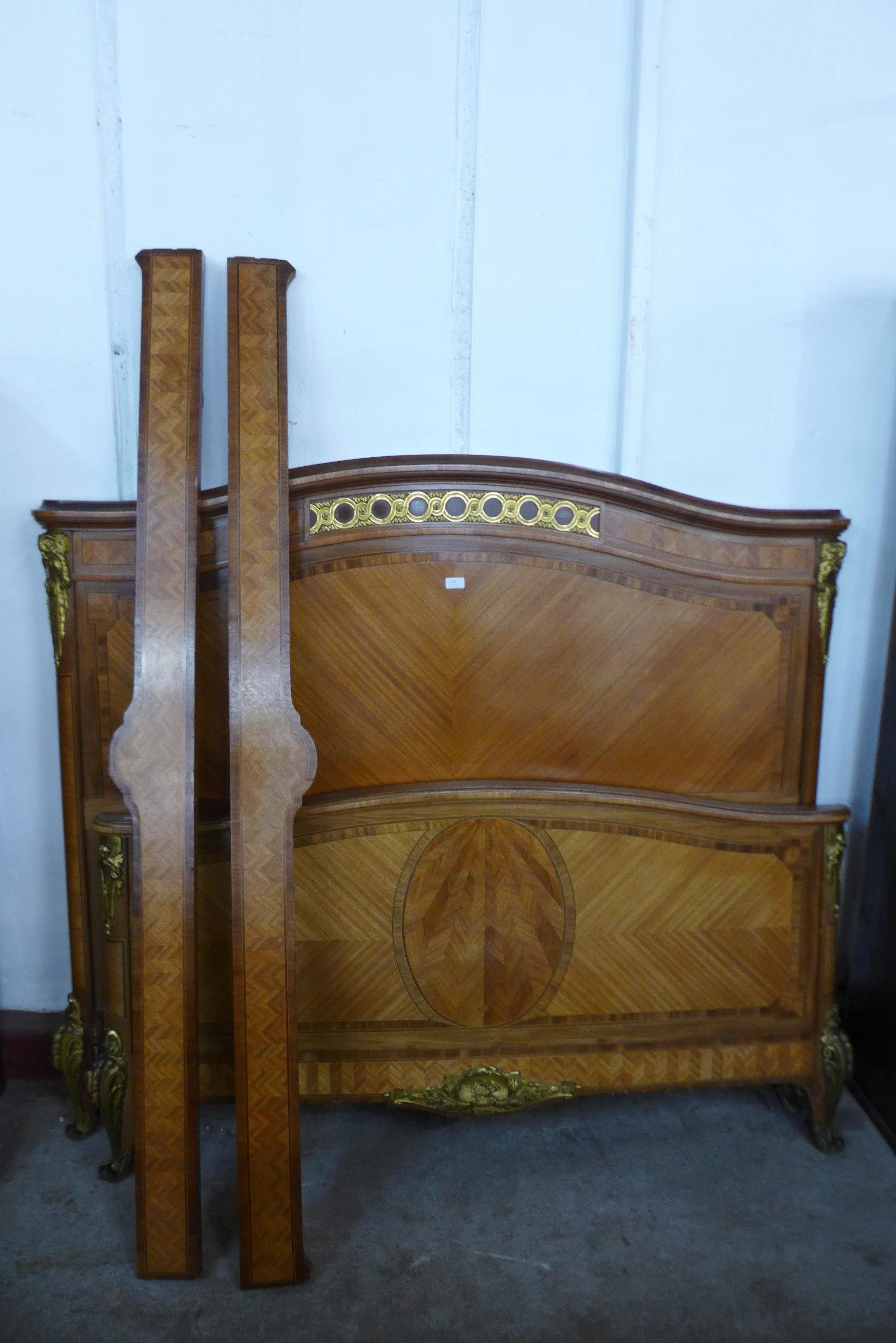 A 19th Century French Empire style inlaid mahogany and gilt metal mounted double bed