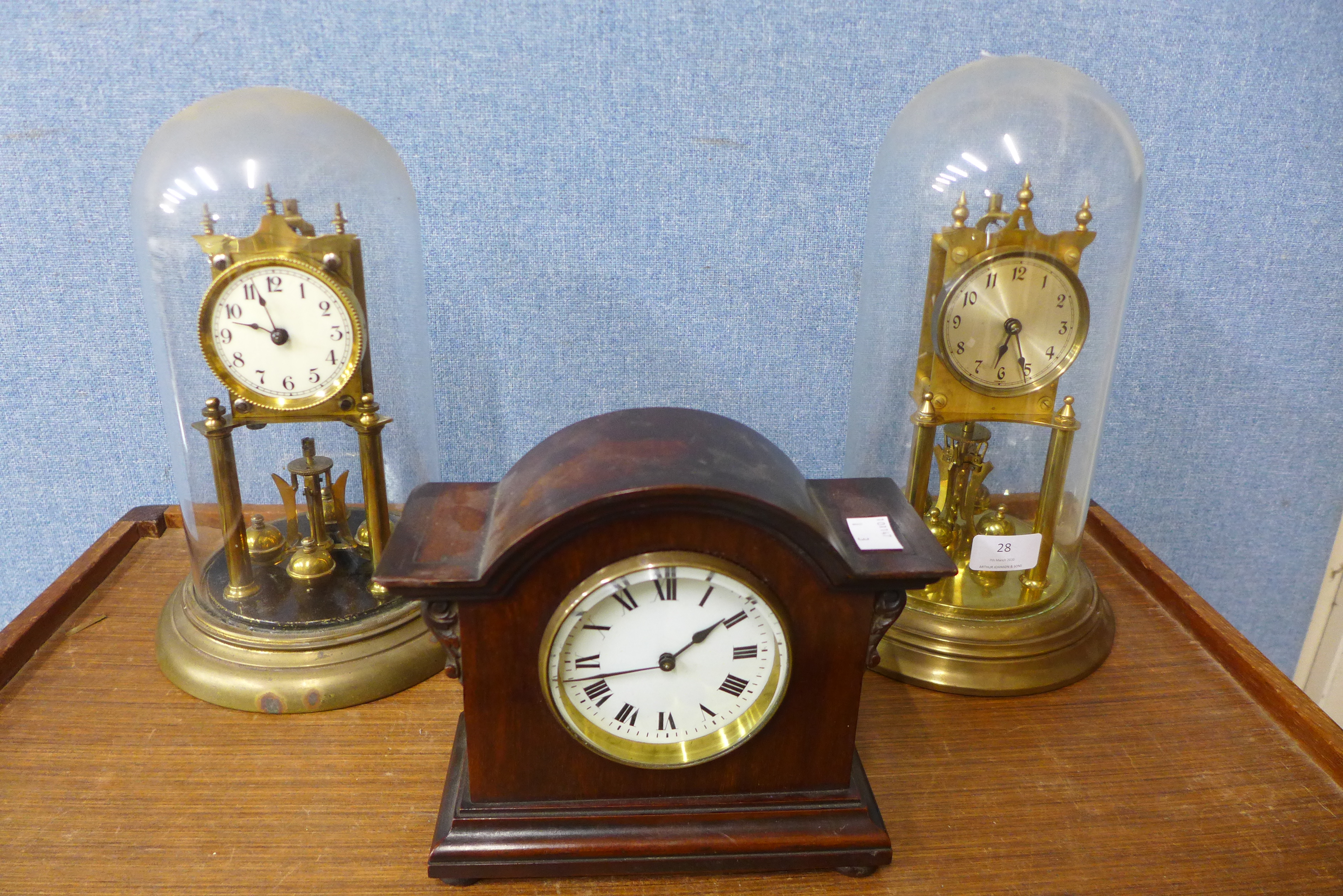 Two brass torsion anniversary clocks and a Japy Freres timepiece