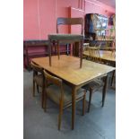 A Danish teak draw-leaf dining table and five chairs