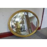 A gilt framed oval mirror