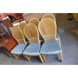 A set of four beech bergere dining chairs