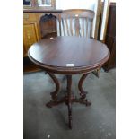 A Victorian style mahogany circular occasional table