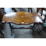 A Victorian burr walnut butterfly top stretcher table