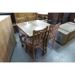 An oak draw-leaf table and four chairs and an Art Deco oak fitted sideboard