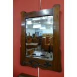 An Arts and Crafts walnut and copper framed mirror