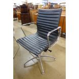 An Eames style chrome and black leather desk chair