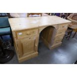 A pine pedestal kneehole desk