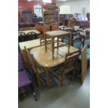 An oak barleytwist extending dining table and four chairs