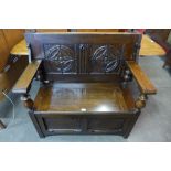 A Gothic Revival carved oak monks bench