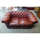 A red leather Chesterfield settee