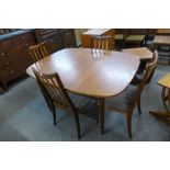A G-Plan teak extending dining table and four chairs