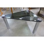 A chrome and glass topped triangular coffee table