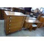 A teak chest of drawers, dressing table and stool