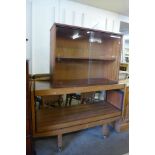 A teak wall mounted unit and a serving trolley