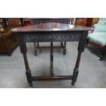 A 17th Century style carved oak corner table