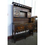 A carved oak geometric moulded barleytwist dresser