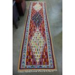 A Persian hand knotted kilim runner rug