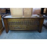 A carved oak blanket box