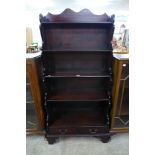 A mahogany open waterfall front bookcase
