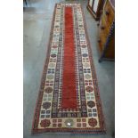 An Eastern red ground runner rug