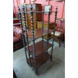 A Victorian rosewood serpentine four tier whatnot