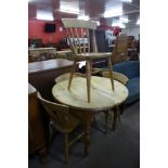 A pine circular kitchen table and four beech chairs