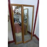 A pair of pine framed mirrors and two small Chinese rugs