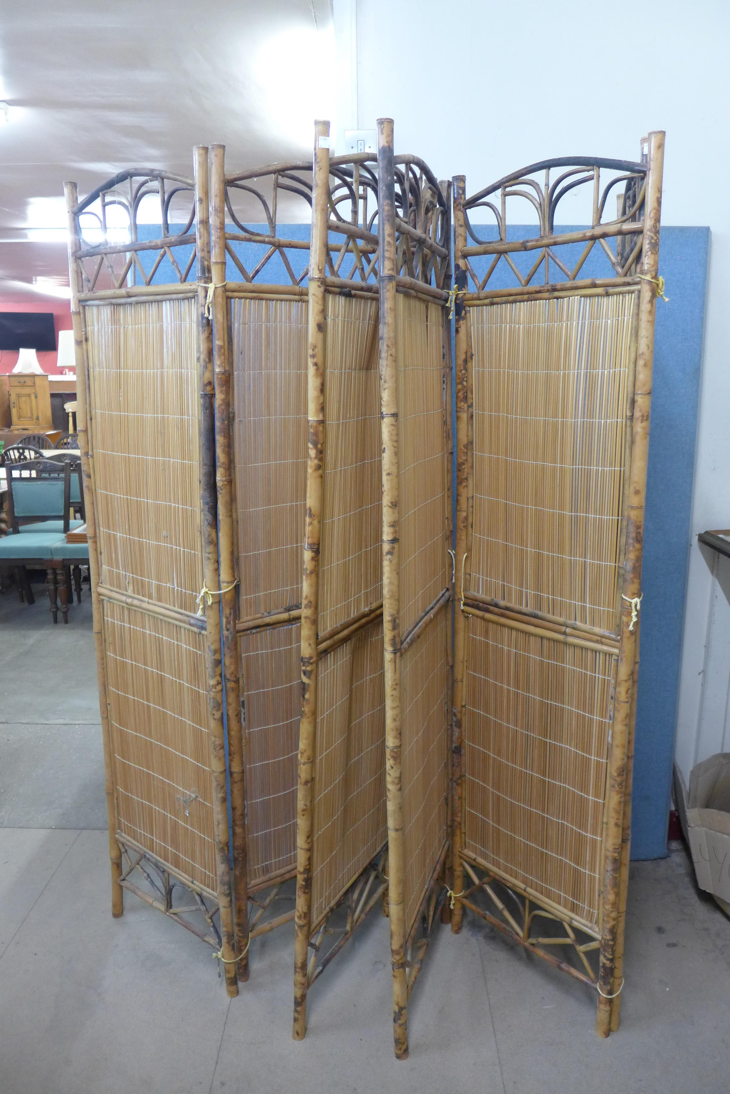 A pair of folding bamboo dressing screens