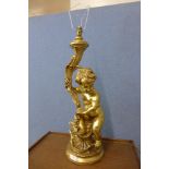 A figural gilt cherub table lamp