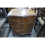 A small mahogany serpentine chest of drawers