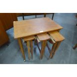 A teak nest of tables and three teak occasional tables