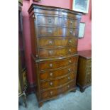 A George III style mahogany serpentine chest on chest