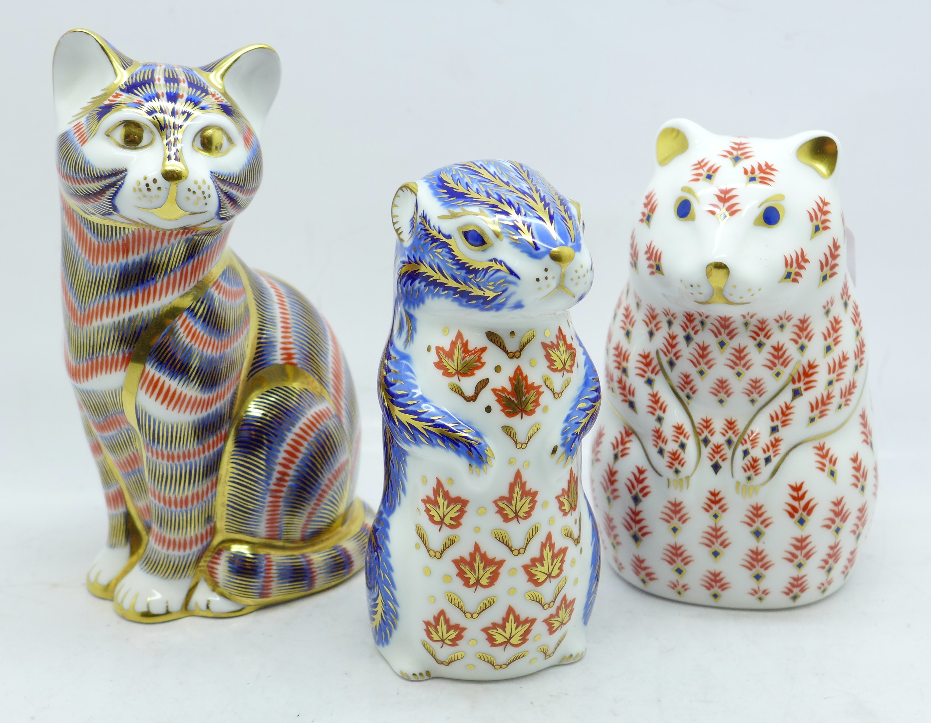 Three Royal Crown Derby paperweights, two with gold stoppers and cat with silver stopper