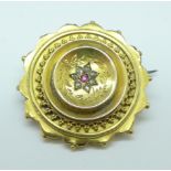 A yellow metal brooch set with old cut diamonds and a ruby, 7.9g, a/f, to the rim