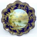An Aynsley cabinet plate, with a blue and gold border, having a central hand painted landscape,