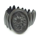 A Victorian Whitby jet bracelet set with a carved oval panel, (panel 5cm, possibly bog oak)