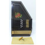 An autoharp with tuner and instruction booklet