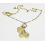 A chain marked 585, 2g, and a yellow metal pendant set with three hearts, 3g