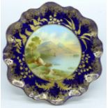 An Aynsley cabinet plate with a blue and gold border, having a central hand painted landscape, Irish