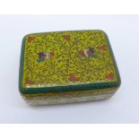 An enamelled white metal pill box decorated with birds